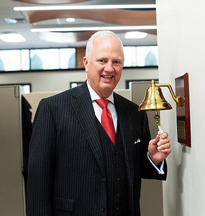 Tony Caldwell ringing the bell