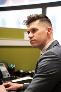 Ryan mclaughlin sitting at desk oaa offices